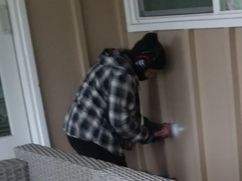 Professional electrician installing an exterior outlet in Cumming