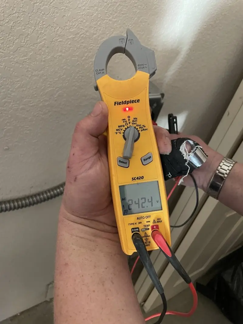 Voltage testing with clamp meter during Recessed Lighting Installation in Cumming